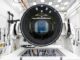 Researchers at SLAC National Accelerator Laboratory are nearly done with the LSST Camera, the world's largest digital camera ever built for astronomy. Roughly the size of a small car and weighing in at three tons, the camera features a five-foot wide front lens and a 3,200 megapixel sensor that will be cooled to -100??C to reduce noise. Once complete and in place atop the Vera C. Rubin Observatory's Simonyi Survey Telescope in Chile, the camera will survey the southern night sky for a decade, creating a trove of data that scientists will pore over to better understand some of the universe's biggest mysteries, including the nature of dark energy and dark matter. (Jacqueline Ramseyer Orrell/SLAC National Accelerator Laboratory)